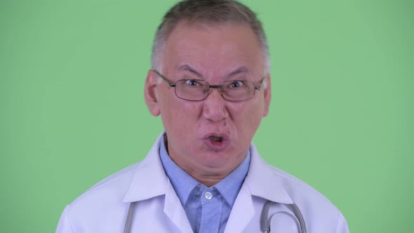 Face of Angry Mature Japanese Man Doctor Shouting and Complaining