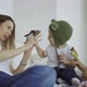 adorable mother and her children, daughter and little son play toys on fingers - VideoHive Item for Sale