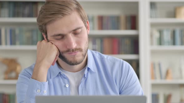 Portrait of Man Taking Nap While Using Laptop