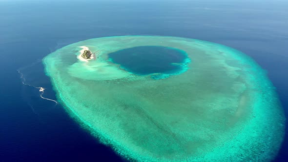 Aerial: Flying over idyllic atoll, exotic travel destination in Wakatobi National Park, Indonesia