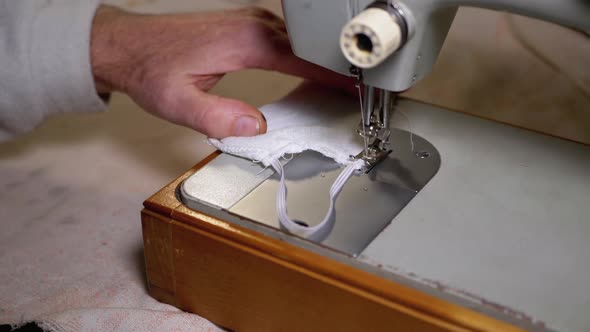 Tailor at Sewing Machine Sews a Homemade Medical Face Mask To Protect Covid-19