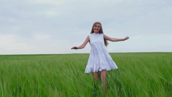The Girl Runs Across a Wheat Field