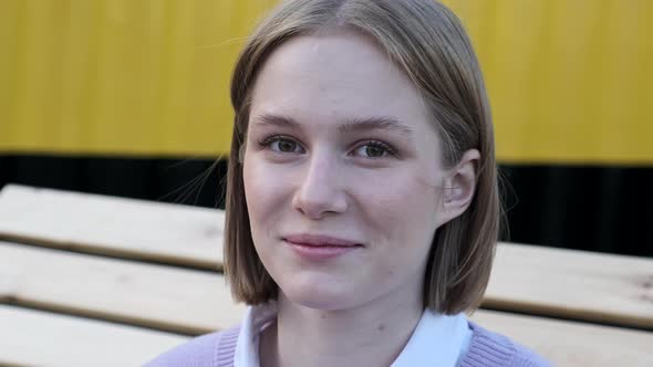 Young Woman Student with Short Fair Hair Waved By Light Wind