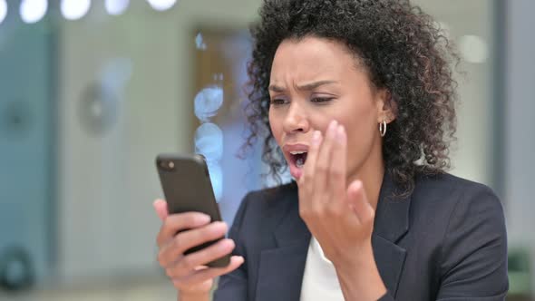 African Businesswoman Upset By Loss on Smartphone