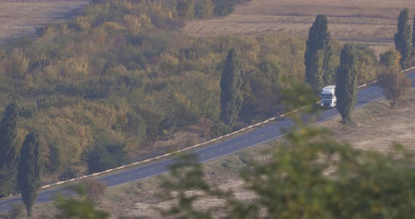 Distant View Of A Country Road With Vehicles