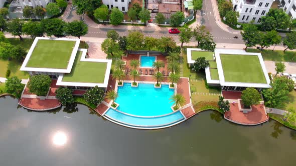 Aerial Flight of a Drone on a Bright Sunny Summer Day Against the Backdrop of a Beautiful Park and