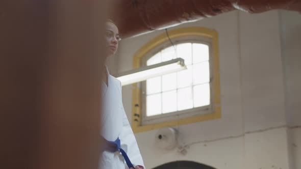 Slider Shot of Girl Bowing Before Starting Karate Workout