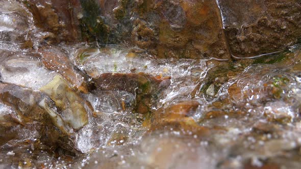 Water and Air Bubbles Flowing Through the Glassy Transparent Ice