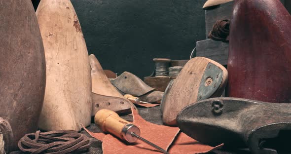 Traditional cobbler workplace with tools, strap, leather and rules.