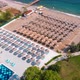Flight Over the Beach with Umbrellas Towards the Pool in a Luxury Hotel - VideoHive Item for Sale