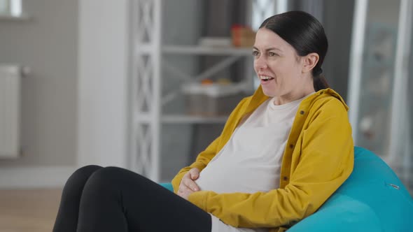 Pregnant Woman Laughing As Baby Kicking in Belly