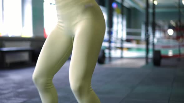 Panning Shot of Slim Fit Sportswoman Squatting in Gym Indoors