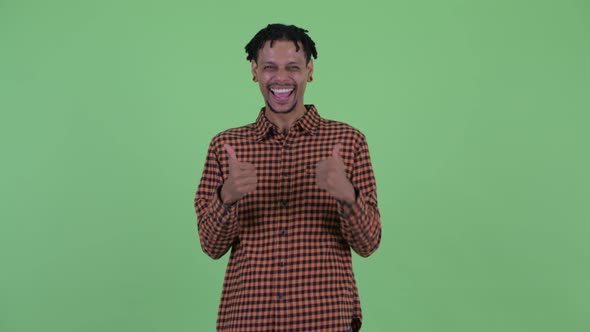 Happy Young Handsome African Man Giving Thumbs Up and Looking Excited