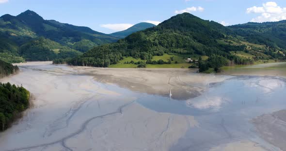 Aerial View Of The Flooded Church At Geamana Village With Mountain Range