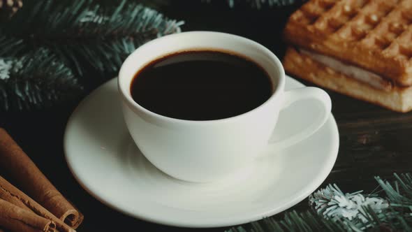 White cup of hot coffee on a brown wooden table