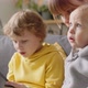 Mom Sitting with Baby as Elder Son Playing on Tablet - VideoHive Item for Sale
