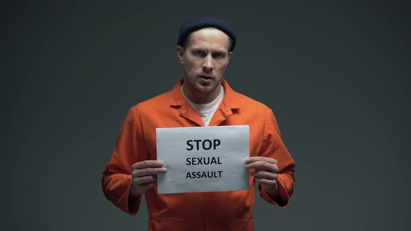 European Male Prisoner Holding Stop Sexual Assault Sign in Cell, Abuse of Force