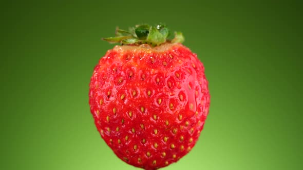 Strawberry isolated on green background, rotation. 4K UHD video