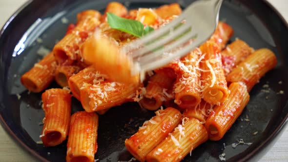 Rigatoni pasta with tomato sauce and cheese - traditional Italian pasta