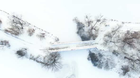 Winter panorama. Frozen trees, bushes and meadows.Winter scene - Old bridge in winter snowy park. Ae