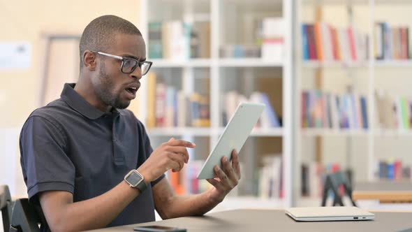 Failure, Young African Man with Loss on Tablet in Library