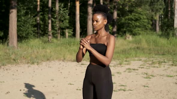The Black Girl Does Sports Exercises in Nature. Healthy Lifestyle Concept