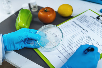 , microbiologist filling forms, following standard operating procedure