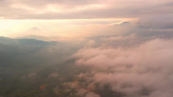 4K Drone Flying through the clouds at dusk or dawn. Aerial top cloudscape