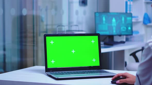 Healthcare Practitioner Using Laptop with Green Screen