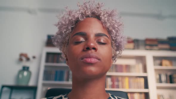 Relaxed African American Woman Meditating While Sitting at Work