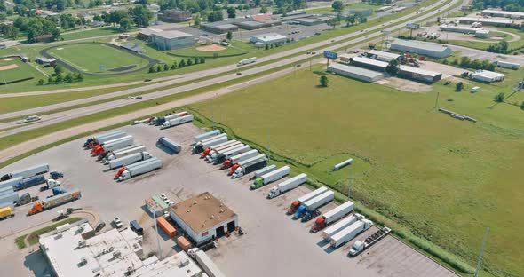 Resting Place with Various Types of Trucks in a Crowded Parking Lot Off Near Highway