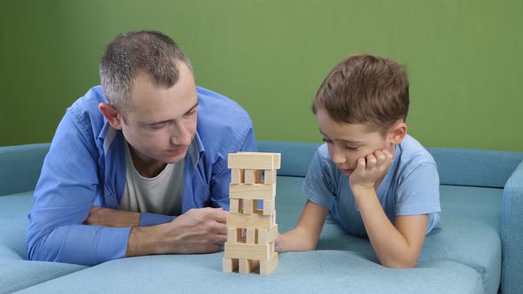 A Caring Father Builds a Tower with His Son