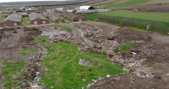 Landscape Of A Dump Hill Near Abandoned Buildings On Countryside. - Aerial Drone Shot