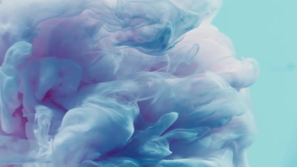 Color Smoke Cloud. Ethereal Aura. Blue Pink Glitter Ink Spreading in Water