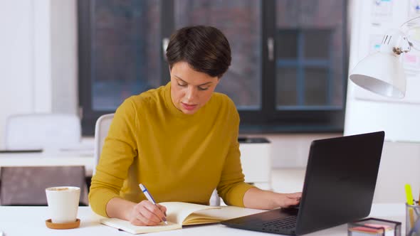 Businesswoman Writing To Notebook at Office 12