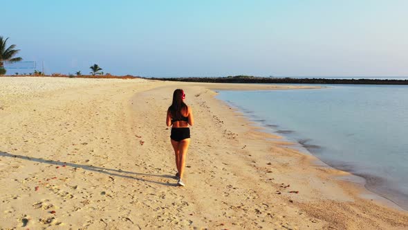 Beautiful ladies tan on exotic seashore beach time by turquoise lagoon with white sandy background o