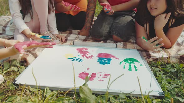 School Children Rejoicing During Outdoor Drawing Lesson with Teacher