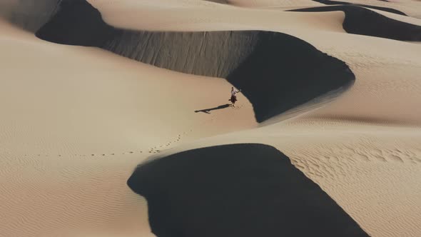 Aerial Girl in Virtual Reality Headset Dancing in the Sand Desert Nature Aerial