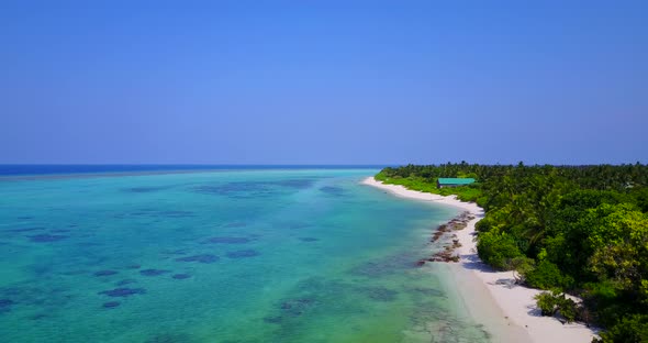 Beautiful flying abstract shot of a sunshine white sandy paradise beach and aqua blue ocean backgrou