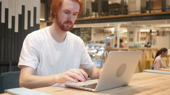 Redhead Beard Man Leaving Cafe After Working on Laptop