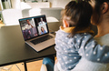 Woman teleconferencing with family on laptop - PhotoDune Item for Sale