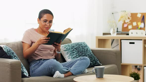 African American Woman Reading Book at Home