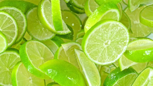 Super Slow Motion Shot of Flying Fresh Lime Slices Towards Camera at 1000Fps