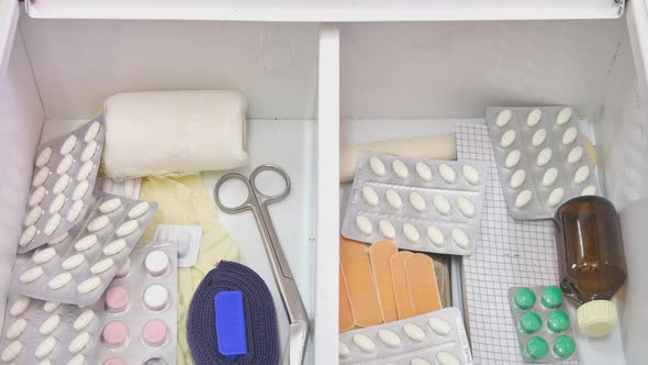 Home first aid kit with medical instruments and pills, timelapse alt