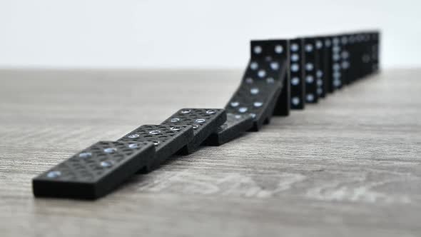 Domino Effect in Slow Motion  Falling Black Tiles with White Dots