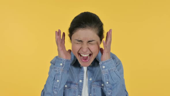 Annoyed Indian Woman Shouting, Yellow Background 