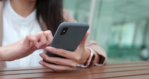 Woman using mobile phone at coffee shop