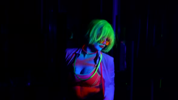 Sexy Lady is Dancing in Dark Nightclub with UV Lights Bright Extravagant Fluorescent Makeup