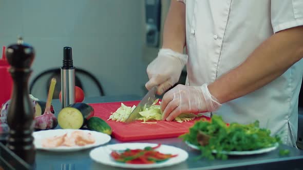 The Cook Cuts Cabbage for Salad