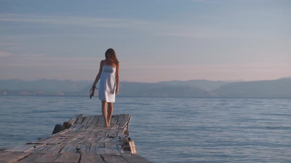 Young girl walking on a pier